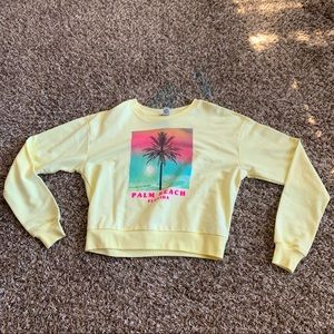 Pastel yellow sweatshirt with neon graphic